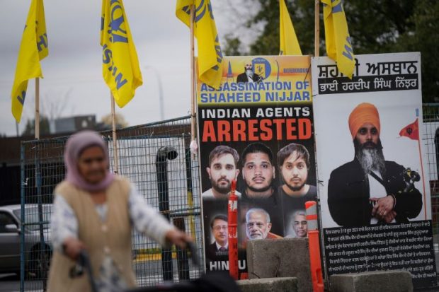 A photograph of late temple president Hardeep Singh Nijjar, back right, is displayed outside the Guru Nanak Sikh Gurdwara Sahib, in Surrey, British Columbia, Tuesday, Oct. 15, 2024. (Photo : EPA / Yonhap)